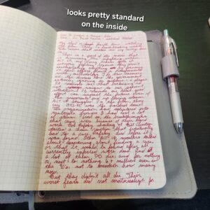 Page of handwritten red text discussing my opinion on How To Survive a Plague. I'm unfortunately not copying all that. Text "Looks pretty standard inside"